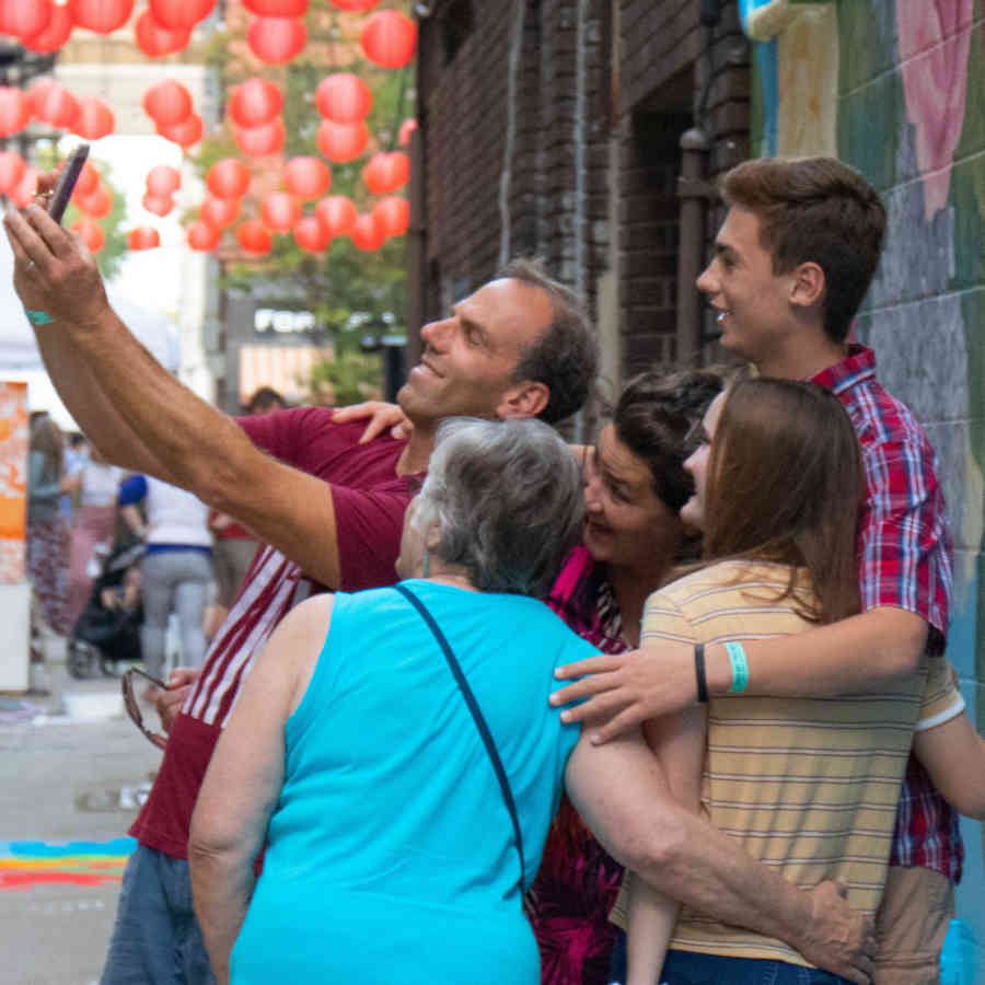 FAMILY TAKING A SELFIE IN DOWNTOWN FW