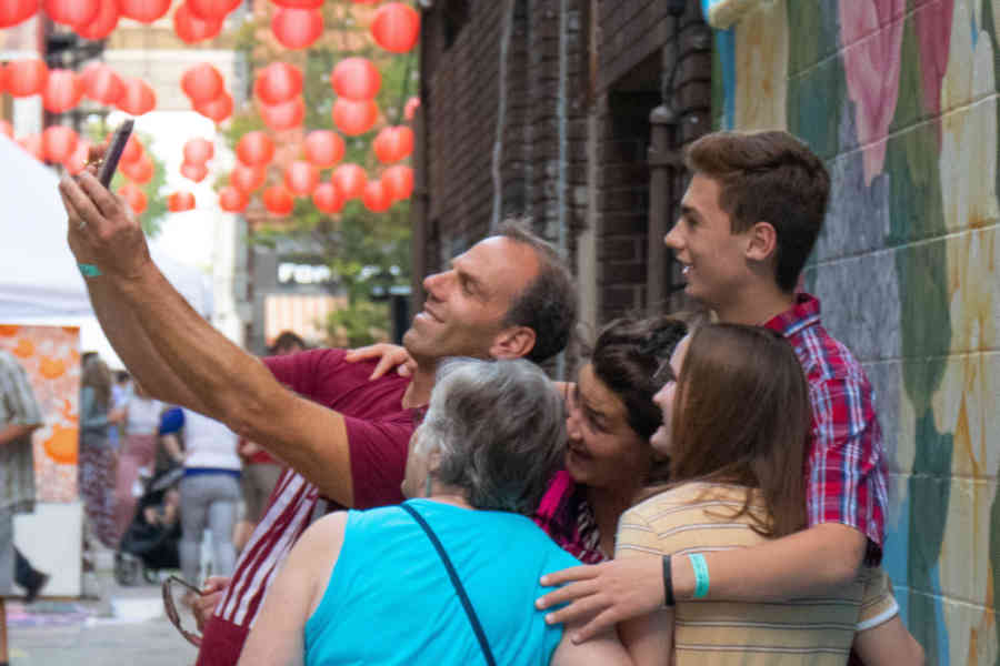 FAMILY TAKING A SELFIE IN DOWNTOWN FW